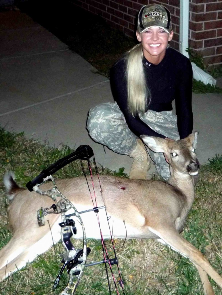 Theresa Vail, in an older photo, with a doe. She loves hunting deer and squirrels. 